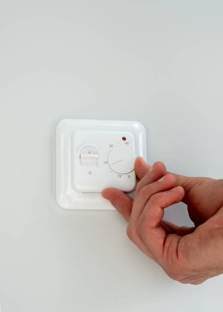 istock One hand adjust thermostat digital in celsius at home 2189941436