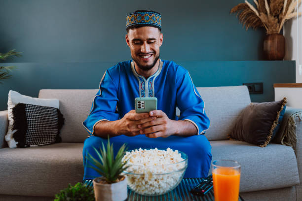 istock Moroccan guy with traditional outfit eating popcorn. 2189941807