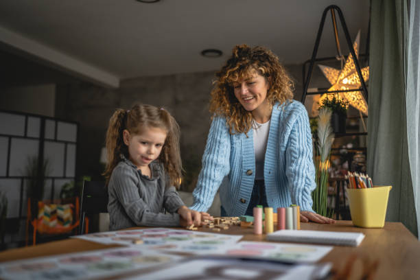 istock little girl practice letters with help speech therapist at home 2189944876
