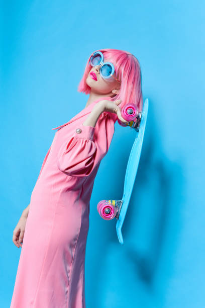 istock woman in sunglasses wears a pink wig studio model unaltered 2189945227