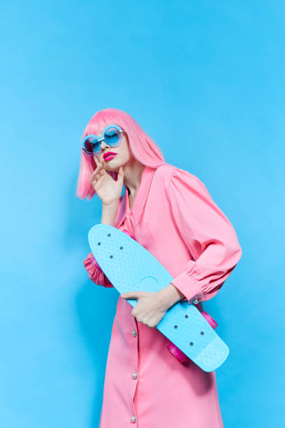 istock woman with skateboard in pink wig studio model unaltered 2189947874