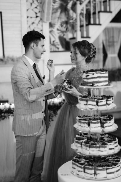 istock newlyweds happily cut and taste the wedding cake 2189947892