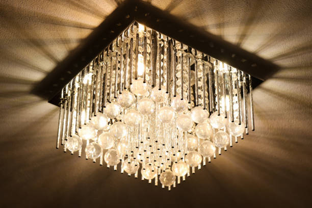 istock Illuminated crystal chandelier with glowing lights. Elegant ceiling decor for luxurious interiors. 2189950109