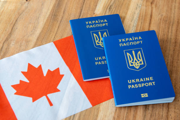 istock Ukrainian passport with Canada flag. 2189951814