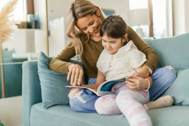 istock Auntie and niece reading a book 2189955315