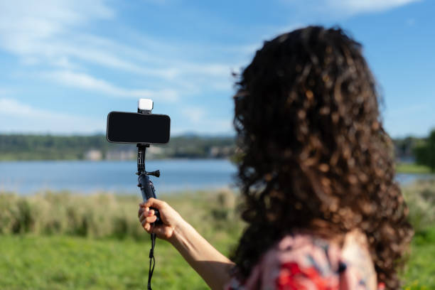 istock Young woman taking a selfie with a gimbal and external light 2189956162