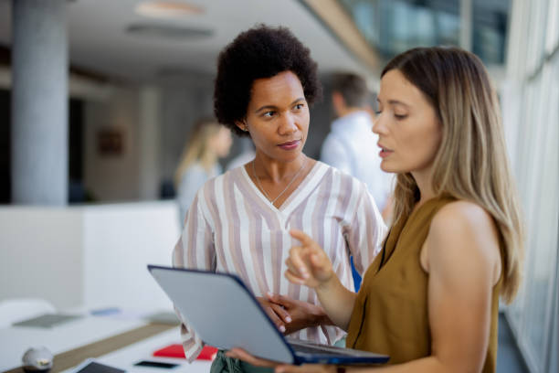 istock Professional Mixed-Race Women Collaborating on Laptop in Modern Office 2189956942