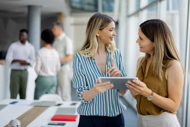 istock Female Professionals Discussing Ideas Using Digital Tablet in Office 2189956943