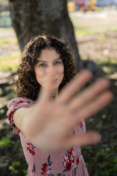 istock Young woman making stop sign with hand in park 2189958084
