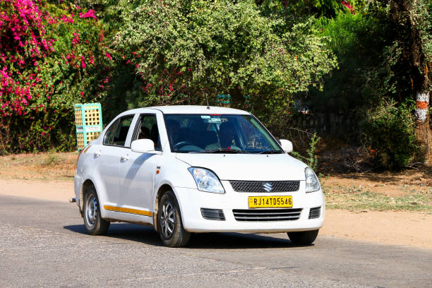 Sawai Madhopur, India - March 1, 2022: Urban minicar Maruti Suzuki Swift DZire in the city street.