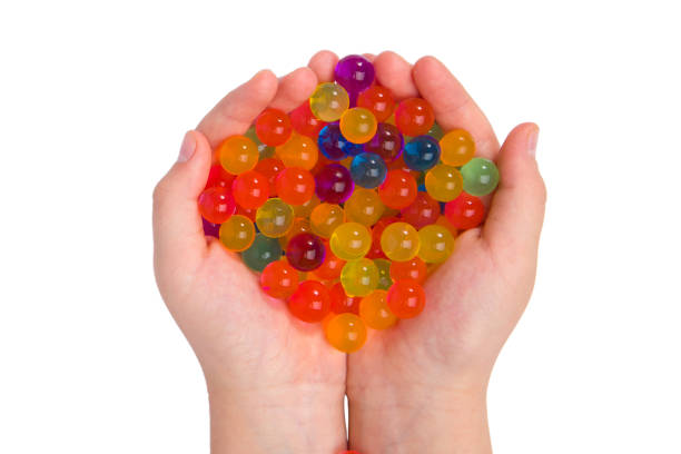 istock Water coloured gel balls on hand. Isolated on white. Orbeez. 2189966405