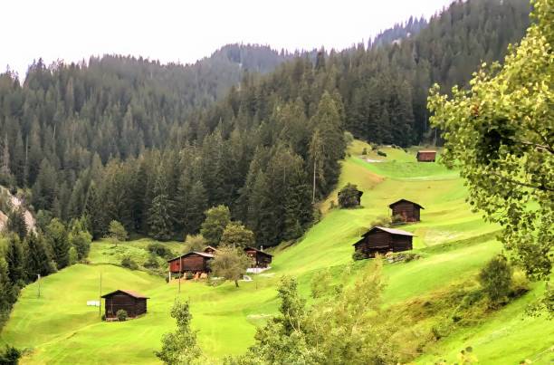 istock Swiss Barns Dot The Rolling Green Meadows and Hillsides 2189974231