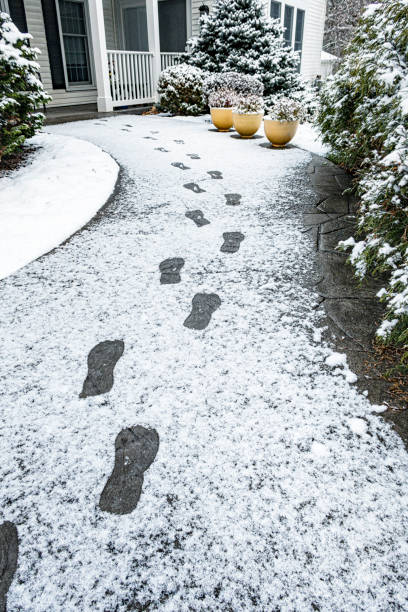 istock Winter Snow Footprints on Ramped Home Front Walkway 2189990639