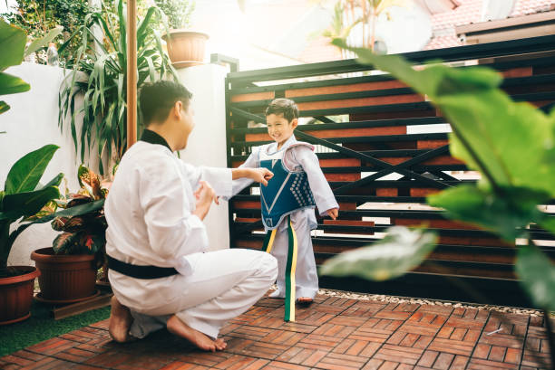 istock martial artist toddler working out with trainer 2189992134