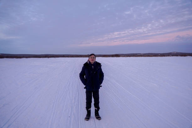istock Man Standing on Snow-Covered Field at Dusk 2189997715