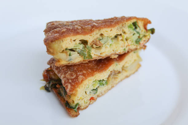 istock Martabak Telur. Pancake with egg, flour, and leek slices, snack from Indonesia. Isolated on white background 2189999607