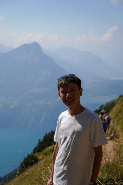 Wooden cross at the Stoos Ridge trail hike in Switzerland with Lake Lucerne in background