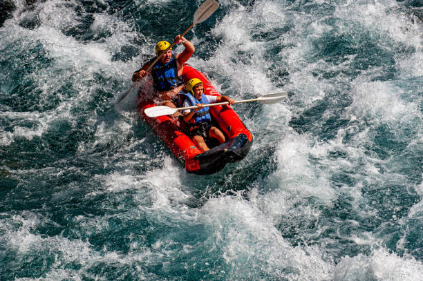 Antalya, Türkiye - October 15, 2013 : Father and son speeding through the canyon stream in a boat. Notes: The Köprüçay River in the Köprülü Canyon National Park in Antalya's Manavgat district is an exciting geography where rafting can be done.