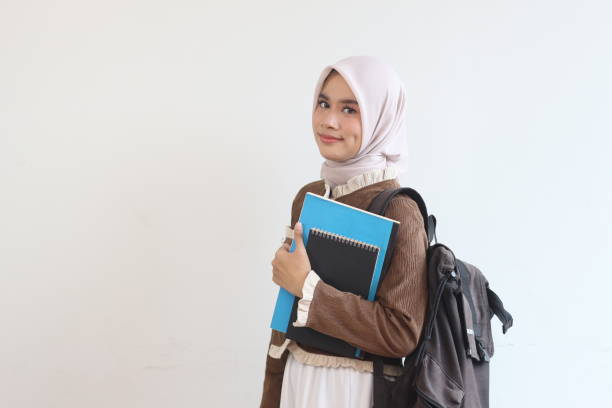 istock Smiling Muslim Student Girl with Books and Backpack Against White Background 2190003773