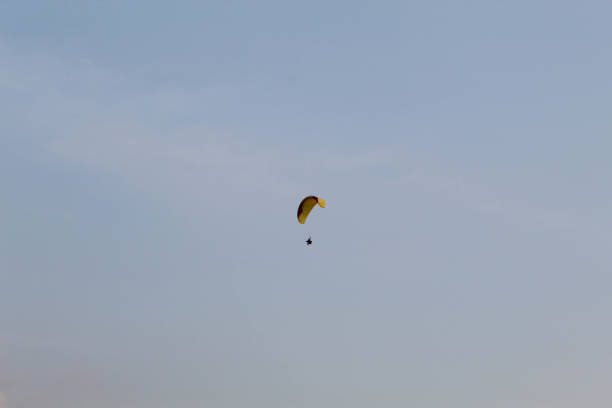 Colorful balloon ascends into a bright blue sky, representing graduates' wishes and aspirations released into the open air for celebration