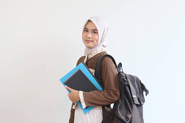 istock Smiling Muslim Student Girl Holding Books and Backpack Ready for Class 2190006387