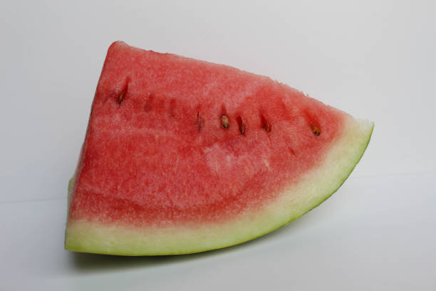 A piece cut of ripe red watermelon, isolated on white background, side view