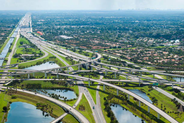 istock View from above of USA transportation infrastructure. American freeway intersection with fast driving cars and trucks in Miami, Florida 2190008211