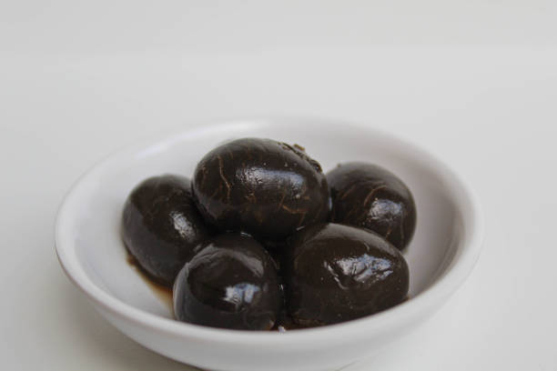 istock Table olives or fermented black olive, in small white bowl, isolated on white background 2190009767