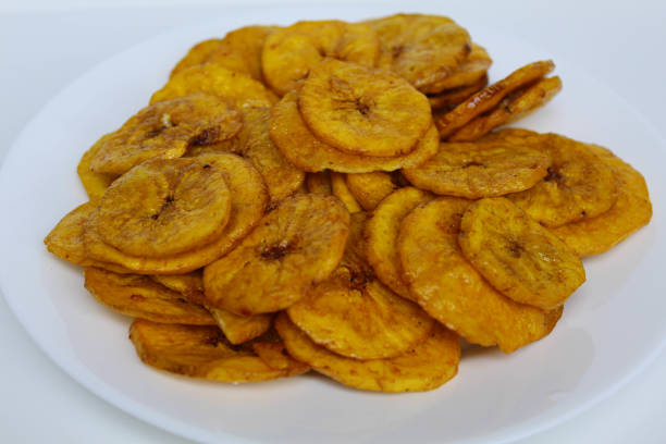 istock Banana coin chip slices on white plate, isolated on white background 2190011135