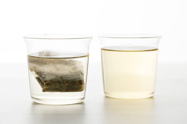 Cup of hot tea with tea bag on white wooden table. selective focus.