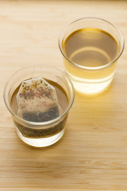 Cup of hot tea with tea bag on wooden table. selective focus.