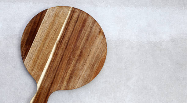 istock Wooden cutting board on grey background. 2190013239