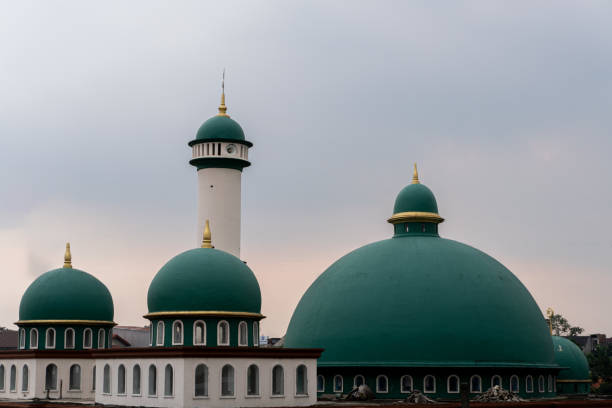 istock Mosque with a green dome in indonesia on cloudy sky 2190014101