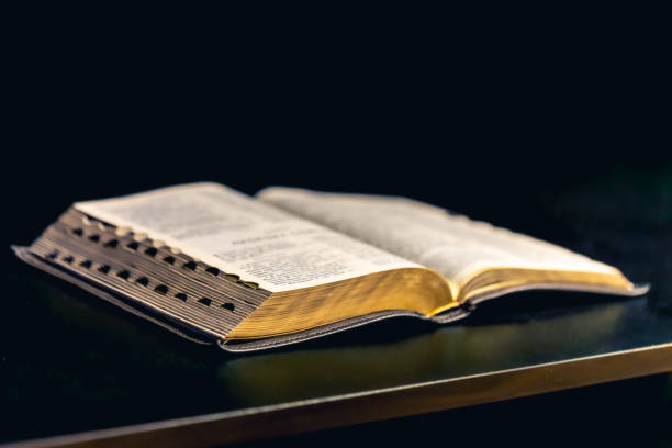 istock Open Bible on a black background. Religion concept. 2190014335