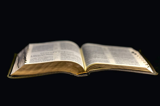 istock Open Bible on a black background. Religion concept. 2190014337