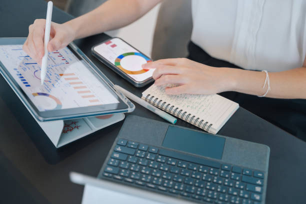 istock Asian woman using a phone applied an AI-enhanced finance chatbot for tracking expenses, showcasing the benefits of AI in financial planning. 2190014533