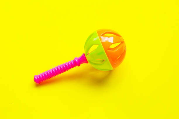 istock Colorful baby rattles on yellow background. Copy space 2190017837