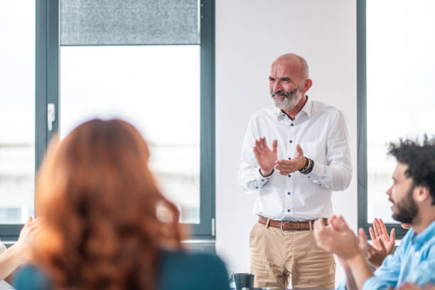 istock Diverse Business Team Joyfully Clapping in a Meeting 2190019781