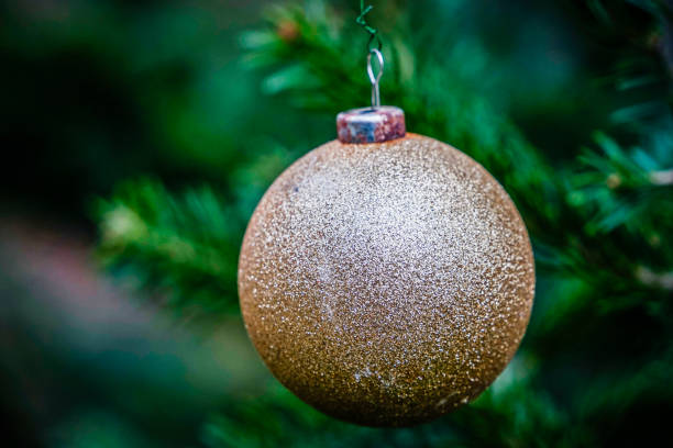 istock Festive golden Christmas bauble on a decorated Christmas tree 2190020386