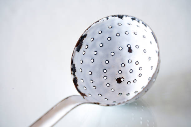 Antique ladle with holes as object photo on the subject of kitchen utensils