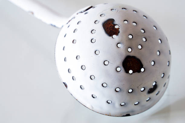 Antique ladle with holes as object photo on the subject of kitchen utensils