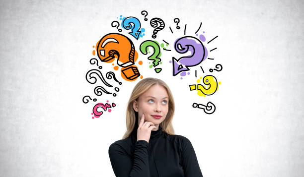 istock Woman thinking with colorful question marks surrounding her head 2190024893