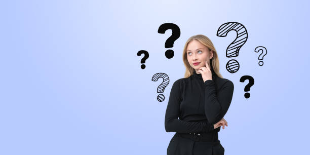 istock Woman thinking with question marks surrounding her on a light bl 2190024960
