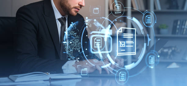 istock Businessman working on laptop surrounded by digital document icons. 2190025537