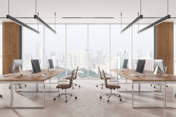 istock Spacious modern office with wooden desks and computers, cityscape view through large windows, minimalist style. 3D Rendering 2190025945