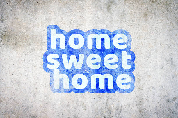 istock Home sweet home, sticker on concrete wall background. 2190028473