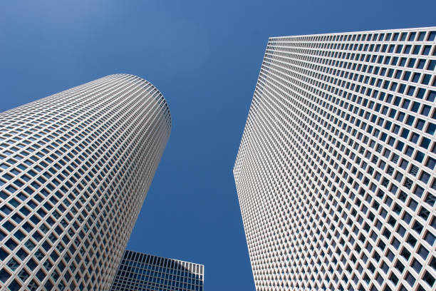 The sleek, geometric facades of the Azrieli Towers stretch into the sky, reflecting the balance of design and innovation in urban spaces.