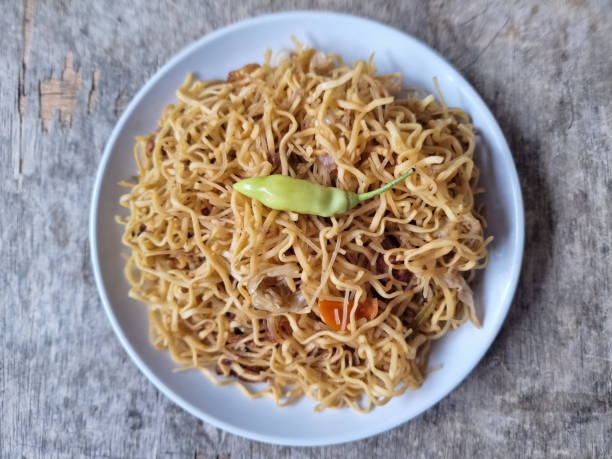 istock Delicious Bakmi Mi Goreng Or Fried Noodle With Carrot, Cabbage, Fried Onion And Green Chilli Pepper. Food Menu. Top View. 2190032131