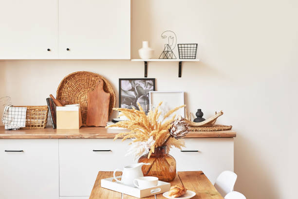 istock Cozy interior of bright loft style kitchen. White kitchen set. Kitchen accessories. Shelves and dishes. Good morning. Stylish luxury interior of studio apartment design with wooden furniture 2190033438
