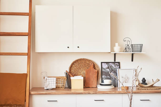 istock Cozy interior of bright loft style kitchen. White kitchen set. Kitchen accessories. Shelves and dishes. Good morning. Stylish luxury interior of studio apartment design with wooden furniture 2190033440